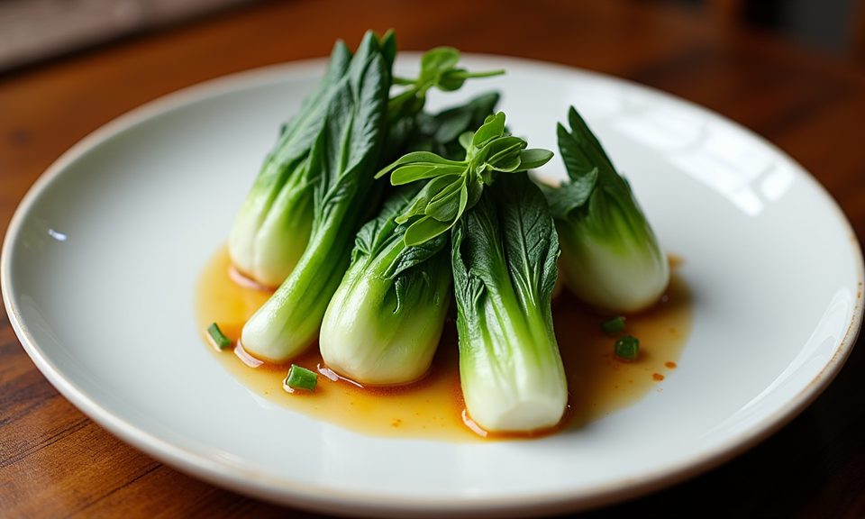 Fresh baby bok choy halved lengthwise on a wooden cutting board
